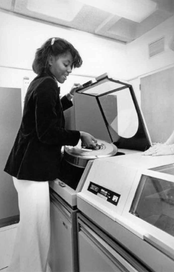 Prospective CSM students in the mid-1970s check a posted schedule of classes in the hallway of the Student Lounge at College Heights