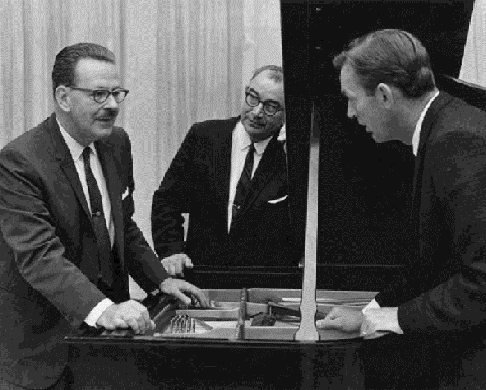 John H. Steinway, music Prof. Fredric Roehr, and KCSM-FM manager Dan Odum